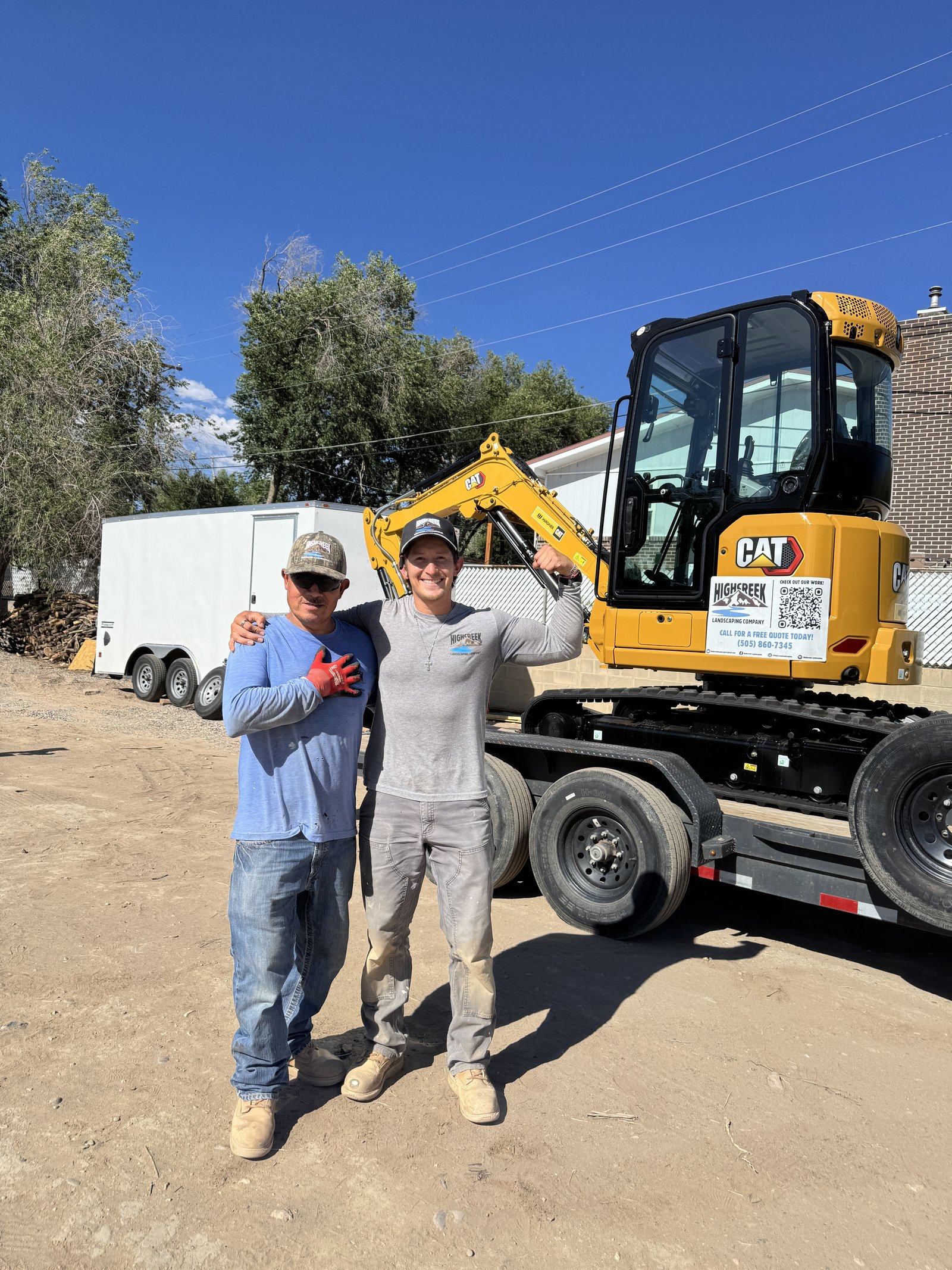 The Highcreek Landscaping & Construction crew with a CAT excavator on a job site